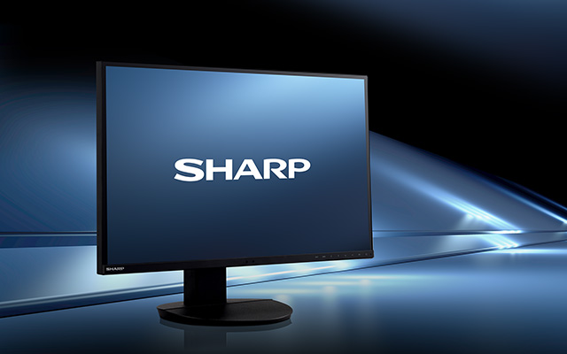 a desktop monitor displaying the Sharp logo